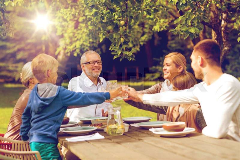 Family, happiness, generation, home and people concept - happy family having holiday dinner outdoors, stock photo