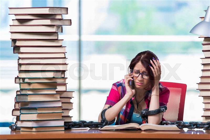 Young female student preparing for exams, stock photo