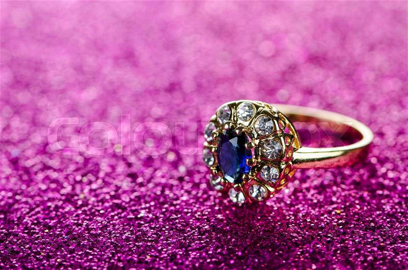 Jewellery ring against shiny background, stock photo