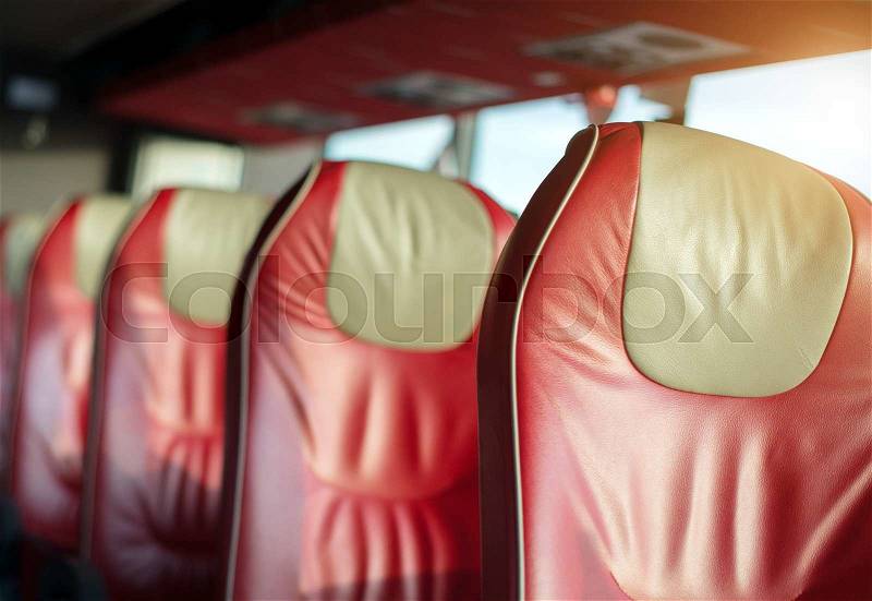 Empty red leather seats in tourist bus, stock photo