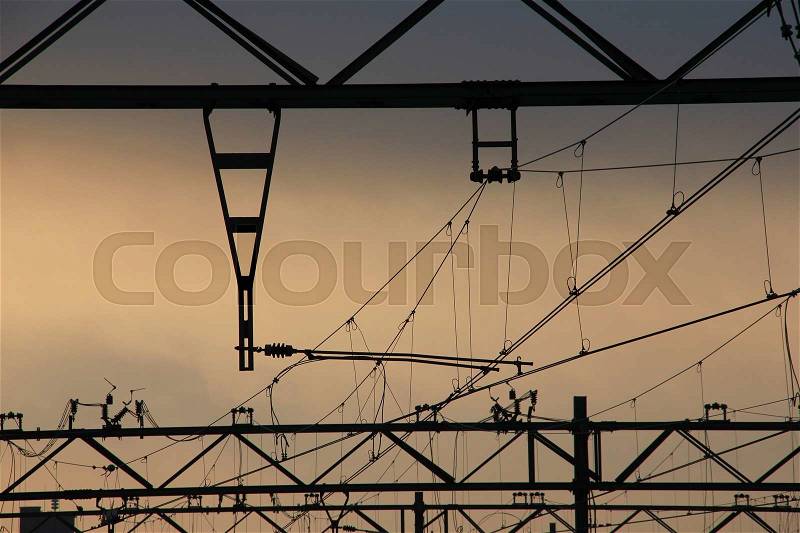 Overhead lines for the transportation of the trains at the railway station in the city The Hague at sunrise in the summer, stock photo