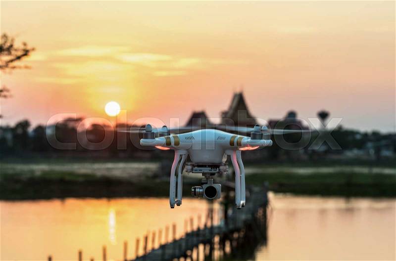 A flying drone armed with camera, stock photo
