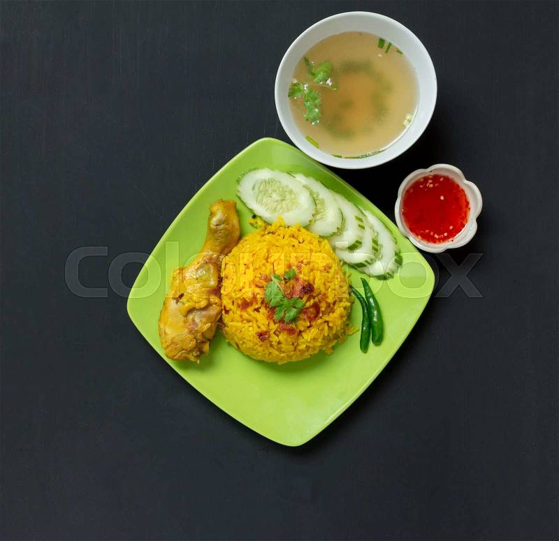 Top view, Chicken Biryani thai style. halal food (Khao Mok Gai) eat with spicy sauce and soup on blac background, stock photo