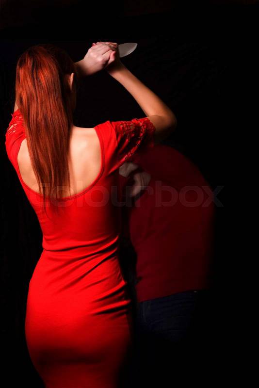Girl in the red dress the knife attack man, stock photo