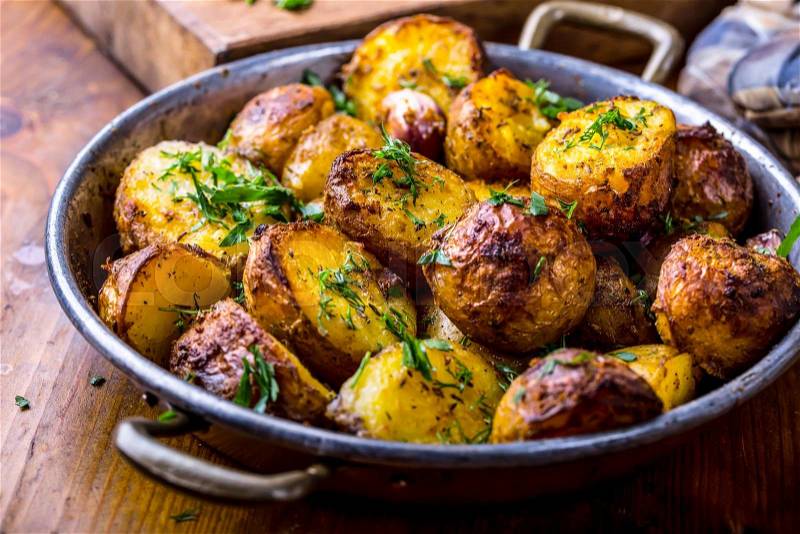 Potato. Roasted potatoes. American potatoes with smoked bacon garlic salt pepper cumin dill parsley - herb decoration, stock photo