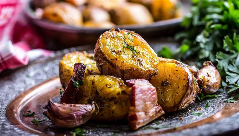 Potato. Roasted potatoes. American potatoes with smoked bacon garlic salt pepper cumin dill parsley - herb decoration, stock photo