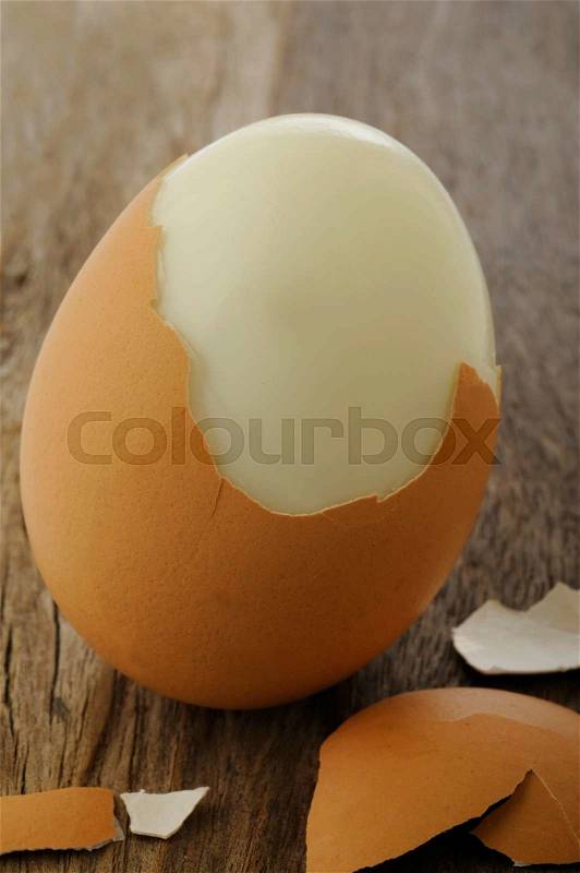 Egg boiled on old wooden background, stock photo