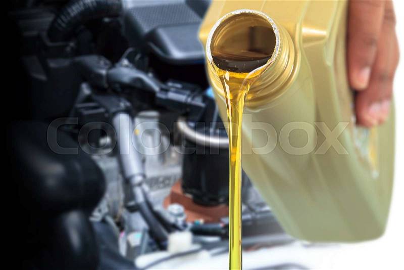 Motor oil pouring, Pouring oil lubricant motor car from bottle, stock photo