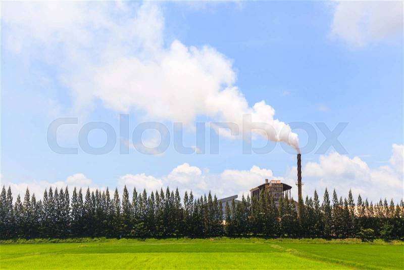 Green factory, Smoke from factory with trees and blue sky, stock photo