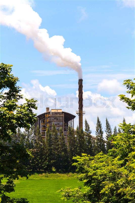 Green factory, Smoke from factory with trees and blue sky, stock photo