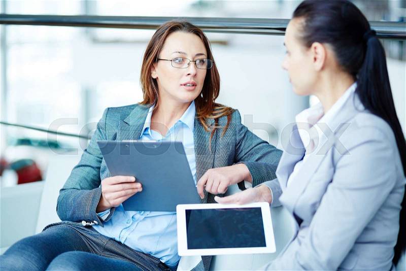 Female managers talking about data, stock photo