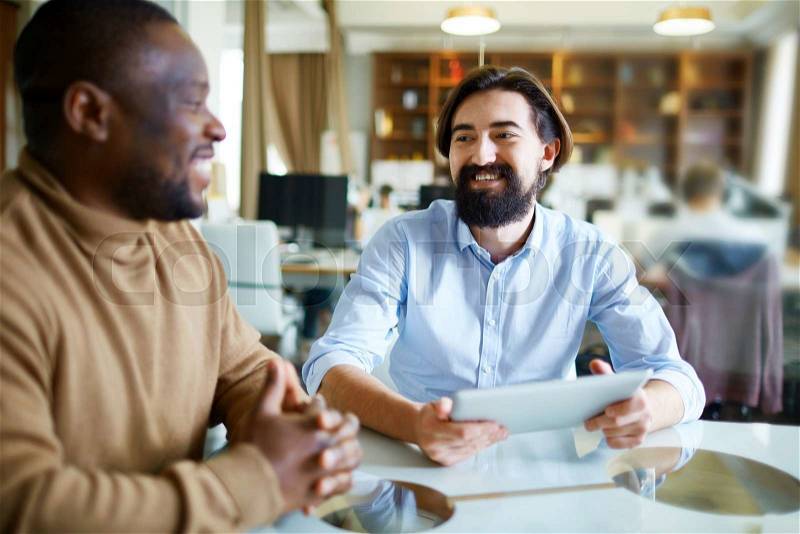 Intercultural men discussing strategy of work, stock photo