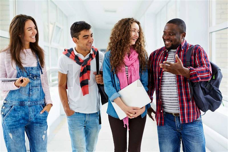 Happy students listening to their friend during talk, stock photo