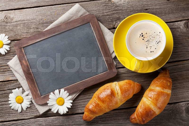 Blackboard for your text, croissants, flowers and coffee cup. Top view with copy space, stock photo