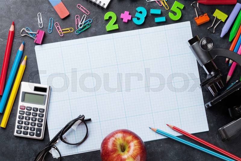 School and office supplies in front of chalk board. Back to school concept with copy space, stock photo