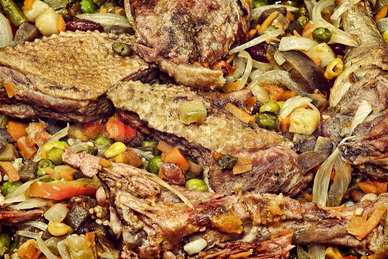 Appetizing roasted meat with vegetables taken closeup.Toned image, stock photo