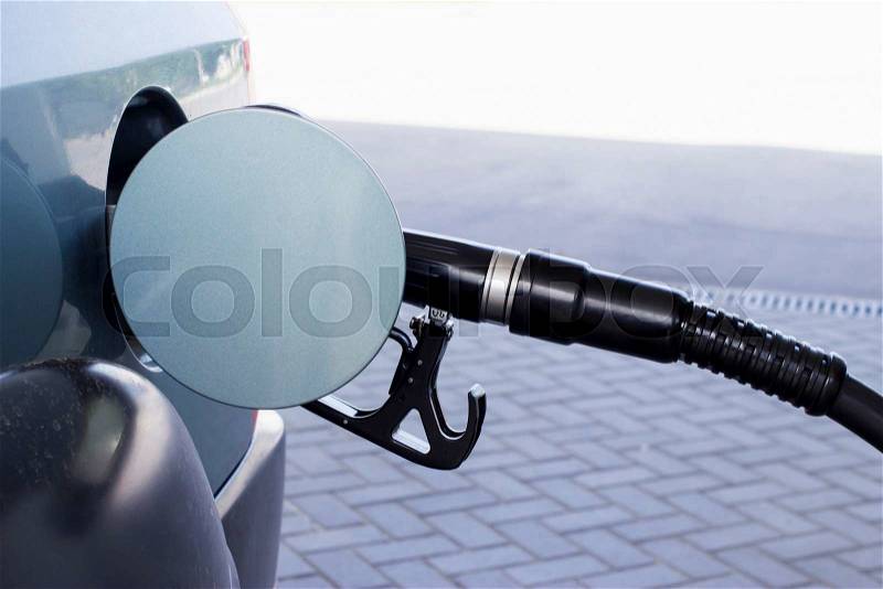 Car fill with gasoline at a gas station, stock photo