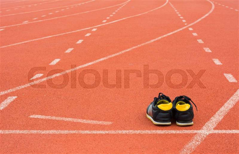 Sport shoes on running track background, stock photo