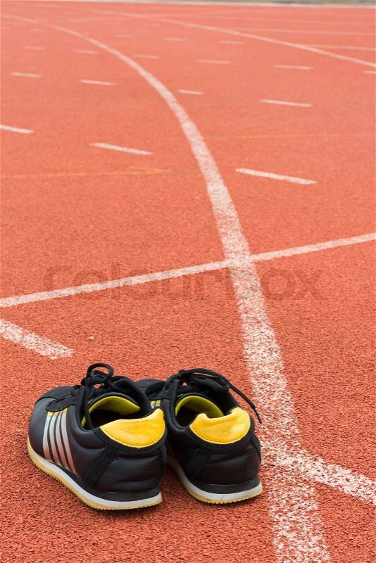 Sport shoes on running track background, stock photo