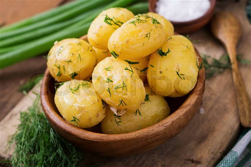 Boiled new potatoes seasoned with dill and butter, stock photo