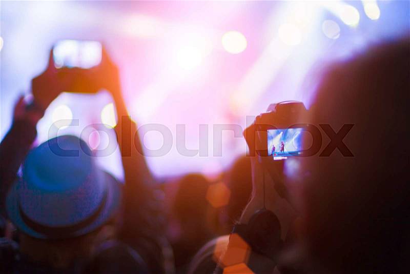 Silhouettes of people and musicians on big concert stage, stock photo