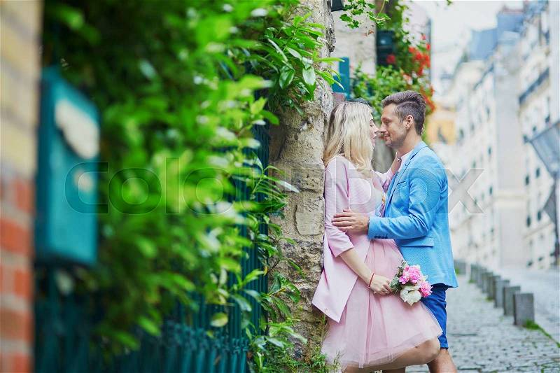 Romantic couple kissing on Montmartre in Paris, France, stock photo