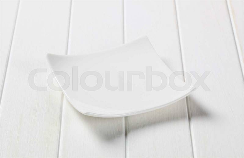 Small square white porcelain plate, stock photo