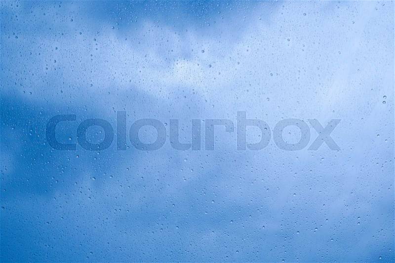 Rain drop on glass with sky background, stock photo