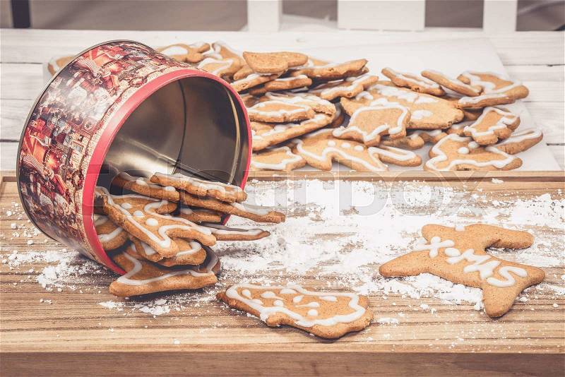 Cake tin filled with Xmas cookies on a table, stock photo