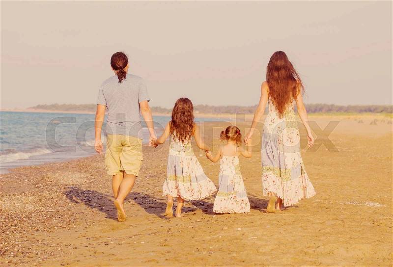Family, unity and happiness concept. Happy family together on the beach, stock photo