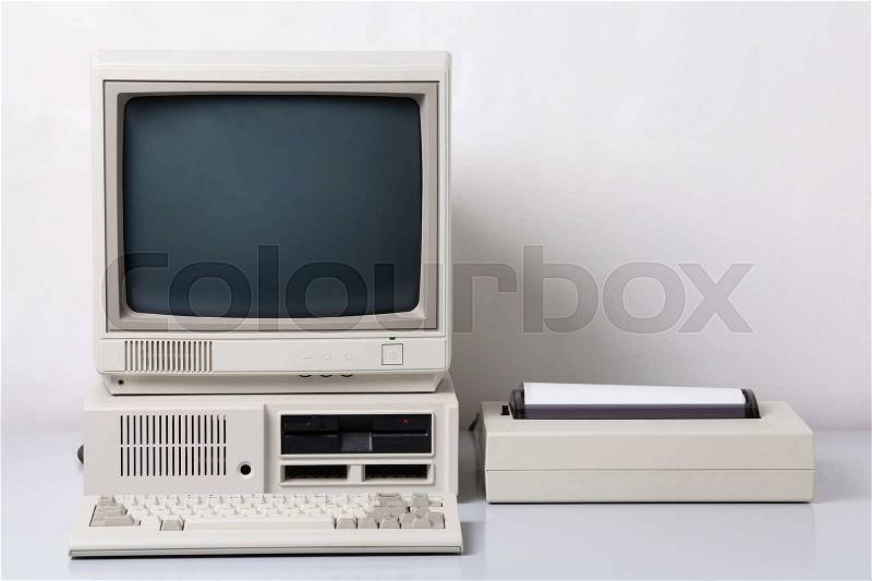 Old personal computer. The system unit, floppy drive, CRT monitor, printer and keyboard on white background, stock photo