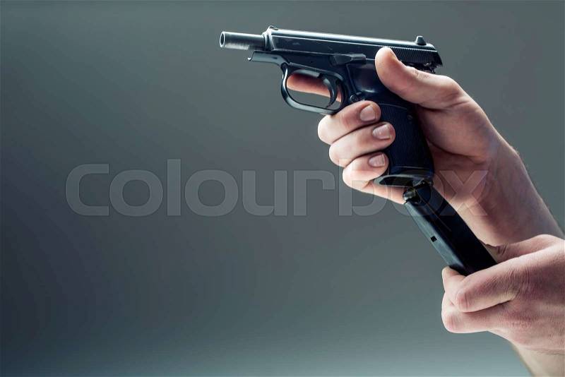 Weapon gun. Men\'s hand holding a gun. 9 mm pistol, stock photo