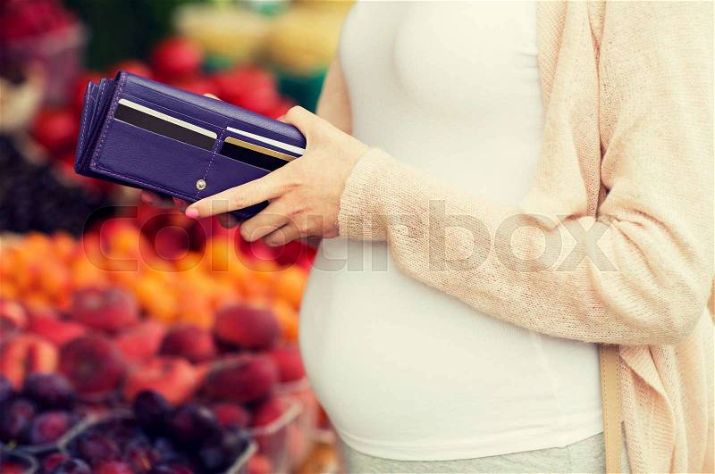 Sale, shopping, pregnancy and people concept - close up of pregnant woman with wallet and and credit cards buying food at street market, stock photo