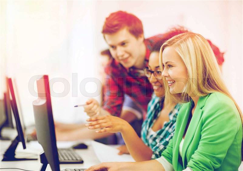 Education concept - students with computer studying at school, stock photo