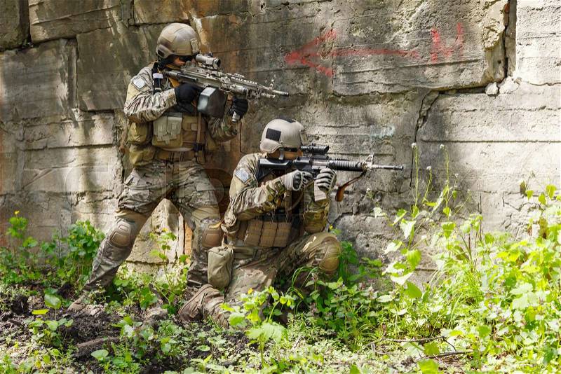 Green Berets US Army Special Forces Group soldiers in action, stock photo