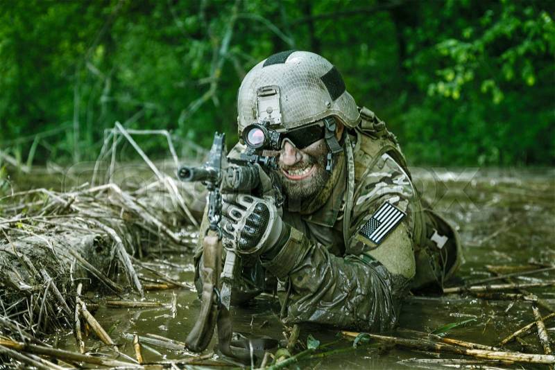 Green Berets US Army Special Forces Group soldier in action, stock photo