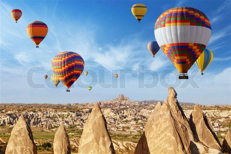 Hot air ballooning is most amazing attraction and adventure in Kapadokya. Colorful hot air balloons flying above unusual rocky landscape in Cappadocia, Turkey, stock photo