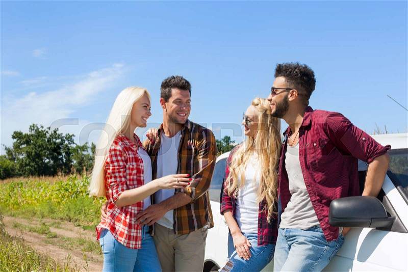 Friends talking chatting outdoor countryside people smile near car summer day trip two couple, stock photo