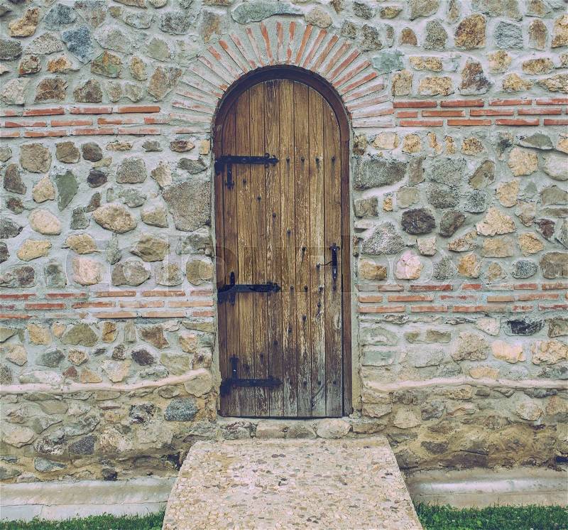 An old wood door on romanian castle wall, stock photo