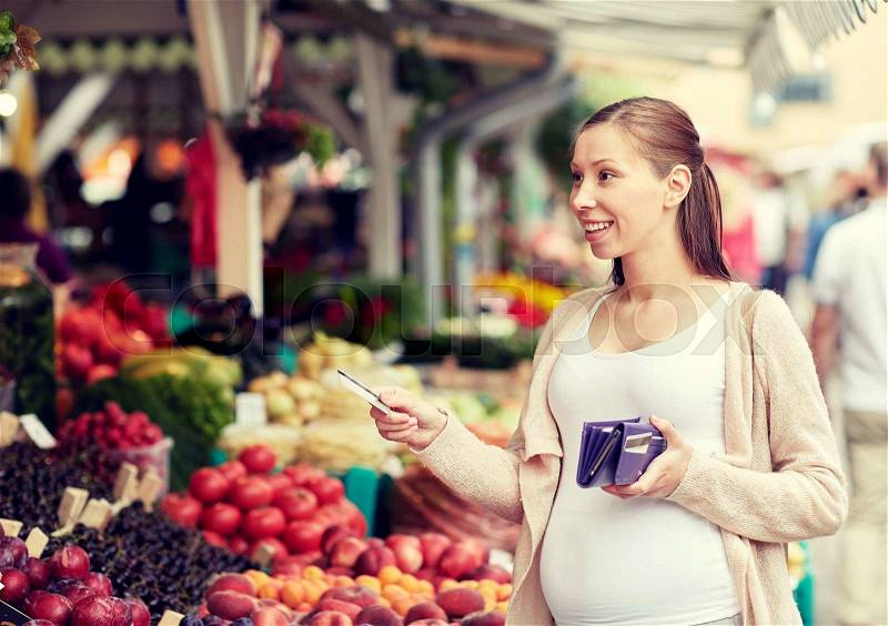 Sale, shopping, pregnancy and people concept - happy pregnant woman with wallet and credit card buying food at street market, stock photo