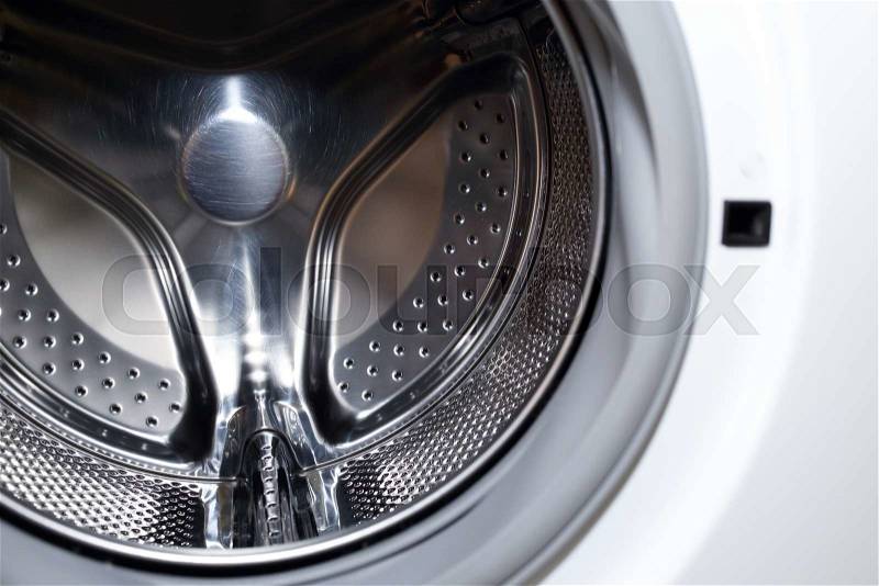 Closeup image of washing machine, abstract metallic texture background, stock photo