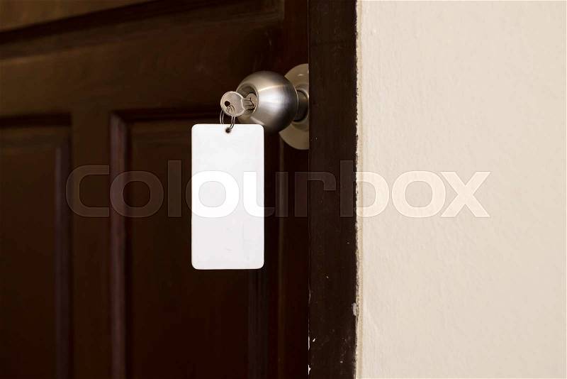 House key with hotel card and hotel door, stock photo