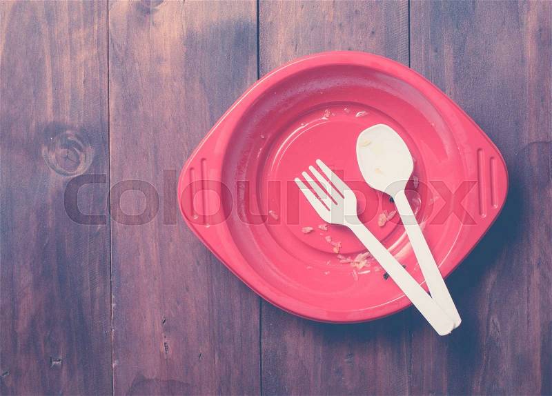 Empty dish after food on wood,top view ,vintage color toned image, stock photo