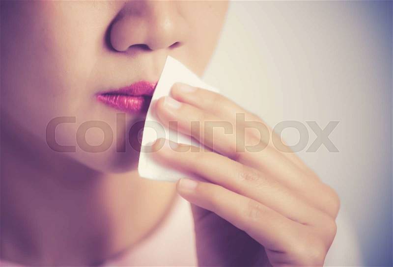 Cleaning lotion make-up remover with cotton pads. Lips close-up ,vintage color toned image, stock photo