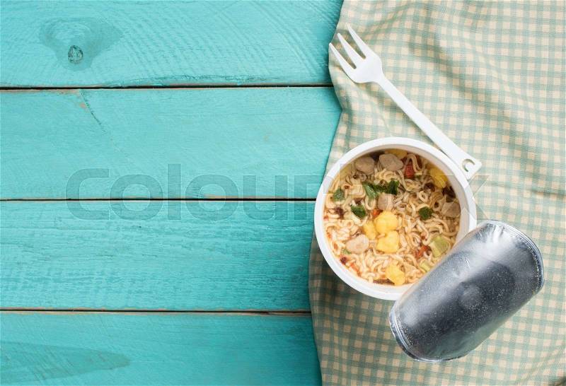 Concept of instant food,Instant noodle cup on blue wood table, stock photo