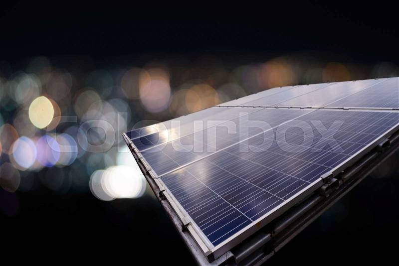 Solar panel with city night light bokeh, stock photo