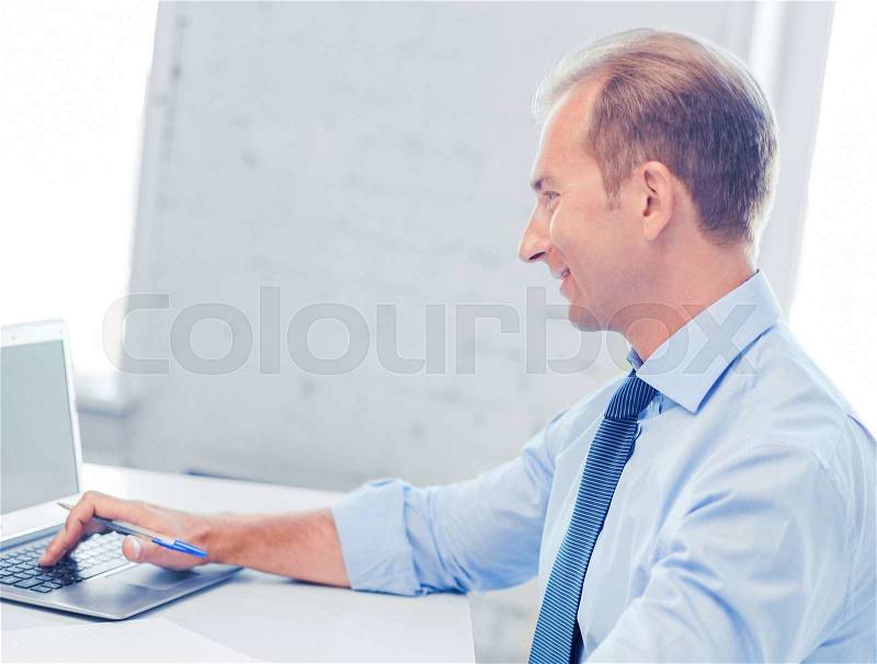 Business, office, school and education concept - smiling businessman working in office, stock photo