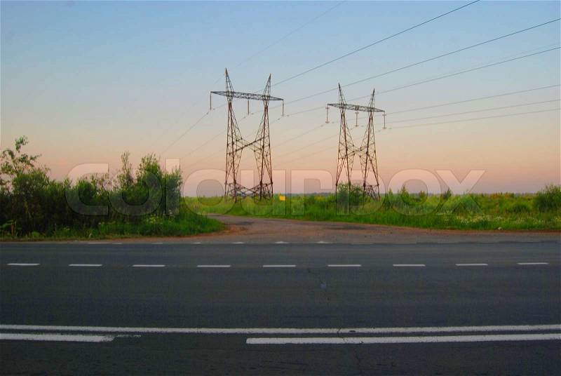 Landscape with asphalted road and high-voltage line, stock photo