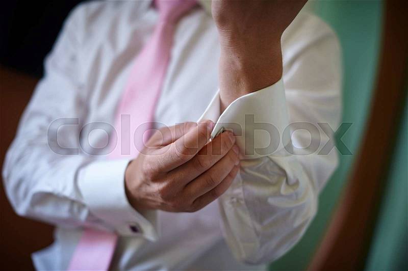 Man in white shirt with pink tie near window dress cufflinks, stock photo