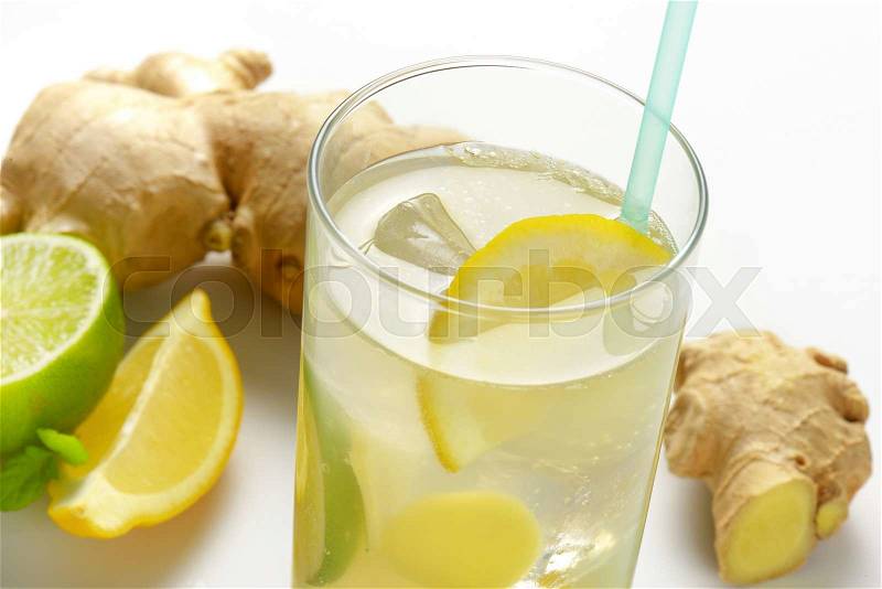 Glass of homemade ginger ale with lemon, lime and ice, stock photo
